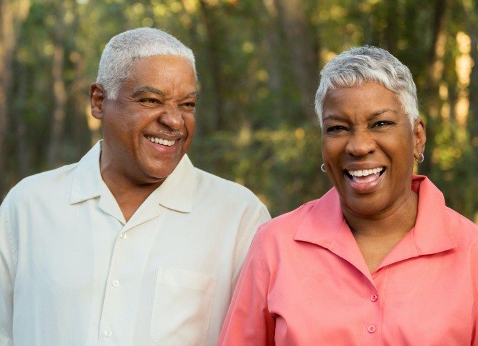 Man and woman smiling after tooth extractions