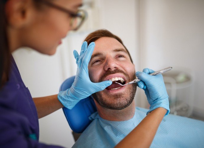 Patient receiving oral cancer screening