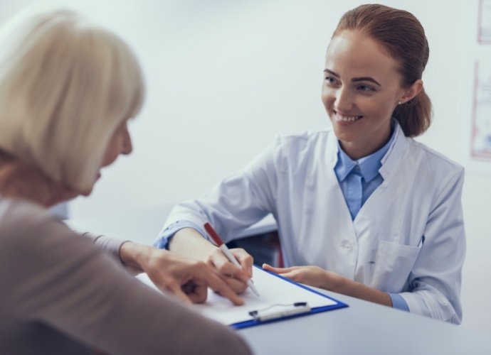 Dentist and patient discussing the cost of dental implants