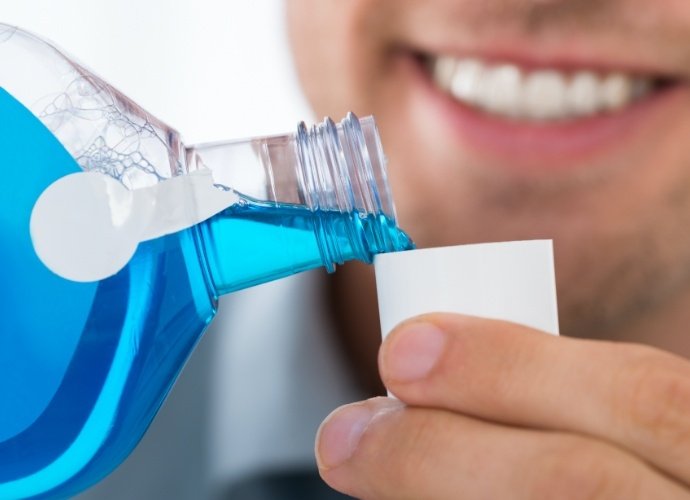 Dental patient using antimicrobial rinse