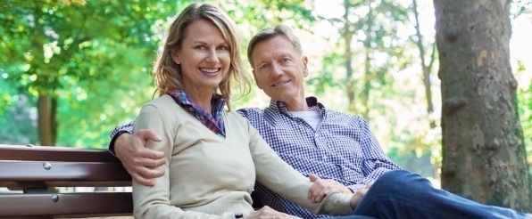 Man and woman with healthy smiles after emergency dentistry