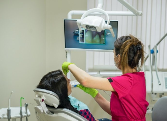 Dentist using intraoral camera to capture smile images