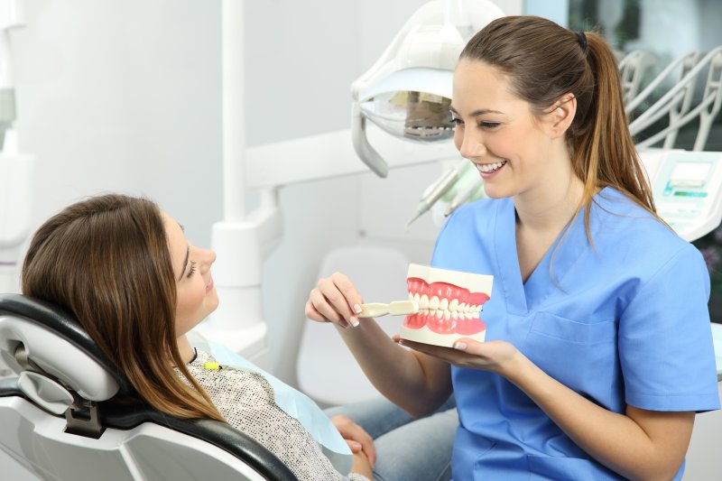 dental hygienist educating patient